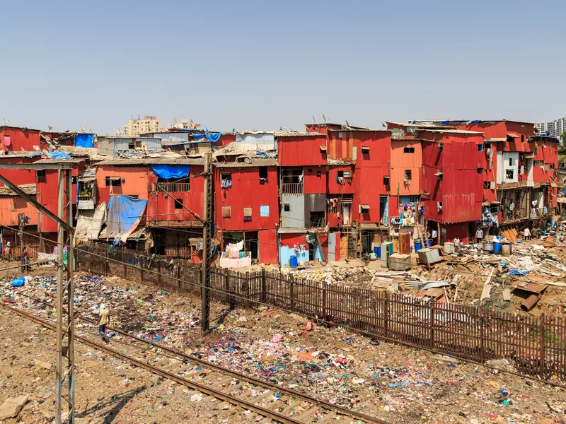 Garib Nagar red light area, Mumbai — settlement shanties pressed right against the railway tracks near Bandra station