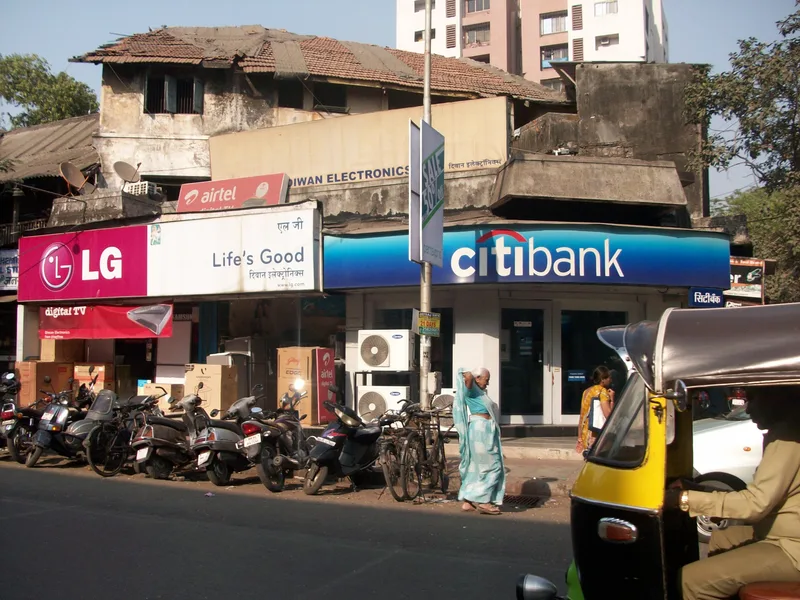 Mulund red light area, Mumbai — an old sloping-roof building above newer shopfronts on S.C. Road