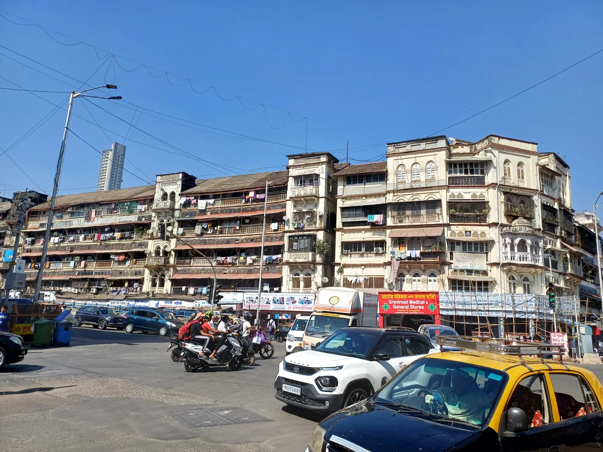 Pannalal Terraces near Grant Road, Mumbai — a weathered heritage chawl with laundry-hung balconies above street traffic